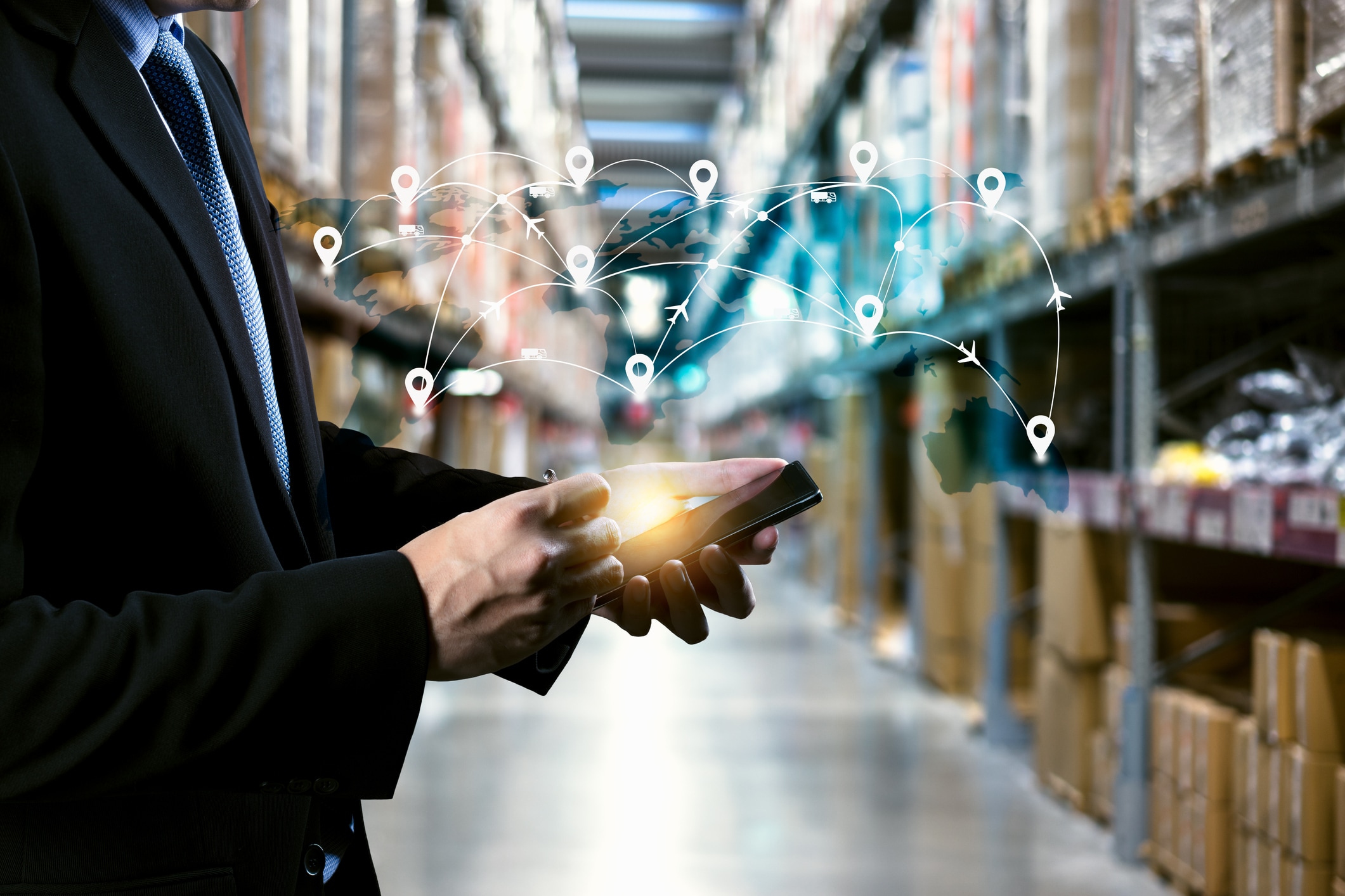 Man with phone in warehouse