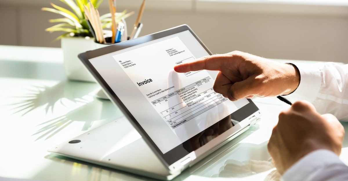 A person's hand on a tablet displaying information